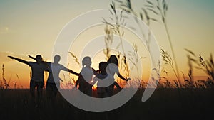 happy family. people in park children a kid together run in park fun at sunset silhouette. mom dad daughter and son run