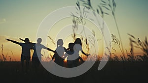 happy family. people in park children a kid together run in park at fun sunset silhouette. mom dad daughter and son run