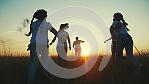 happy family. people in park children a kid together run in park at sunset silhouette. mom dad daughter and son run