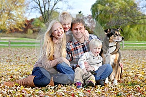 Happy Family and Pet Dog Autumn Portrait