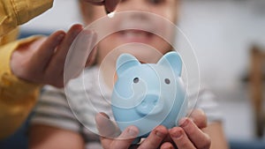 happy family piggy bank. mom and daughter a put coins in the piggy bank. mortgage loan future savings home in crisis