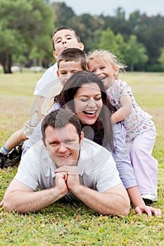 Happy family piled up on the park