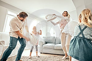 Happy family, pillow fight and playing in living room for bonding, fun holiday or weekend together at home. Mother