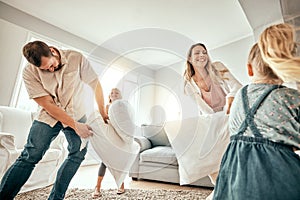 Happy family, pillow fight and playing in living room for fun bonding, holiday or weekend together at home. Mother