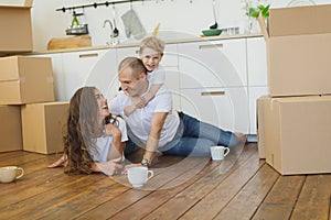 Happy family planning their new apartment. Happy family with cardboard boxes