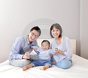 Happy family play on bed