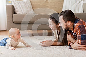 Happy family playing with baby at home