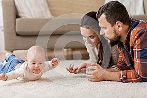 Happy family playing with baby at home