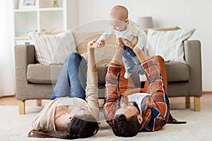 Happy family playing with baby at home