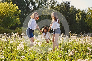 Happy family playing with baby on the lawn in summer