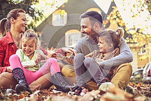 Happy family playing at backyard, autumn season.
