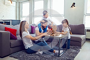 Happy family playing board games at home.