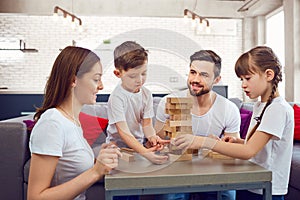 Happy family playing board games at home.