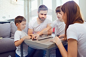 Happy family playing board games at home.