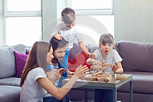 Happy family playing board games at home.