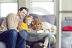 Happy family playing board games on the table.