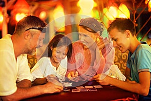 Happy family playing cards