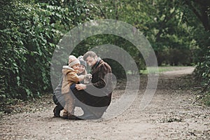 Happy family playing with dog fox terrier Outdoor