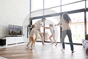 Happy family playing hide and seek at home