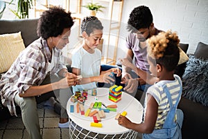 Happy family playing jenga together at home.