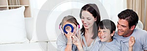 Happy family playing with a magnifying glass