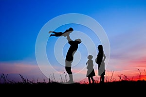 Happy family playing on nature summer silhouette