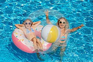 Happy family playing in outdoor pool