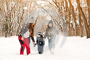 Happy family playing with snow outdoors