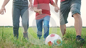 happy family playing soccer with ball in the park. children playing football in the park. happy family a kid dream