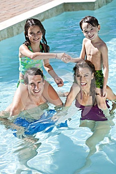 Happy Family Playing In A Swimming Pool