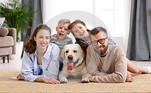 Happy family playing with their favorite pet dog   at home