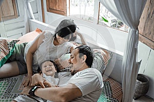 Happy family playing together on the bed