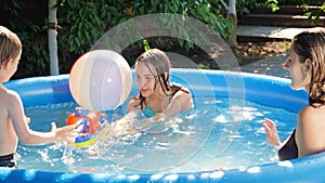 Happy family playing with toy boat ship with little boy. in outdoor swimming pool. Concept of happy and cheerful family