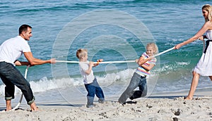 Happy family playing tug of war