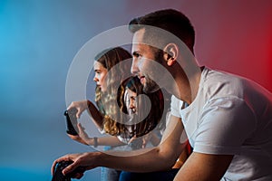 Happy family playing video games together at club