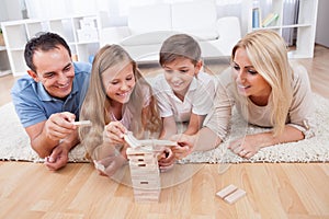 Happy Family Playing With The Wooden Blocks