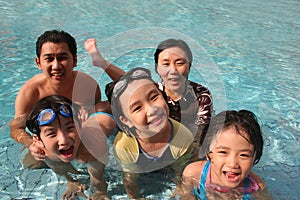 Happy family in the pool