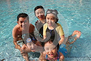 Happy family in the pool