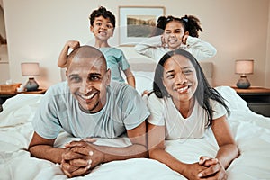 Happy family, portrait and bonding in bed, having fun and playing in their home together. Face, smile and children with