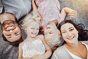 Happy family, portrait and children with mom and father relaxing and smiling from top view from a park outdoors. Kids