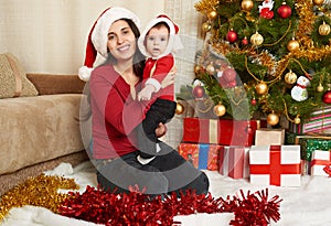 Happy family portrait in christmas decoration, winter holiday concept, decorated fir tree and gifts