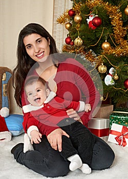 Happy family portrait in christmas decoration, winter holiday concept, decorated fir tree and gifts