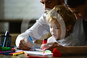 Happy family portrait having fun together. Kids early arts and crafts education, drawing. Father mother and child son