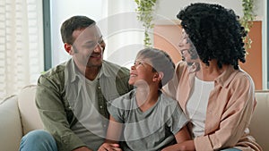 Happy family portrait multiracial African american parents mom dad and adopted Caucasian son custody smiling laughing