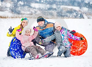 Happy family portrait outdoors at winter time