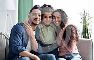 Happy Family Portrait. Smiling arabic parents and their little daughter posing together