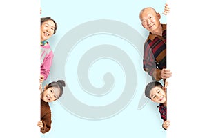 Happy Family posing behind blank white board