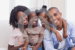 Happy family posing on the couch together