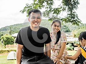 Happy family posing for pictures together in nature. Travel and vacation lifestyle concepts