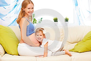 Happy family. Pregnant mother and baby daughter having fun relax